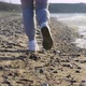 Closeup of the Legs of a Runner Running Along the Beach and Dodging the Waves - VideoHive Item for Sale