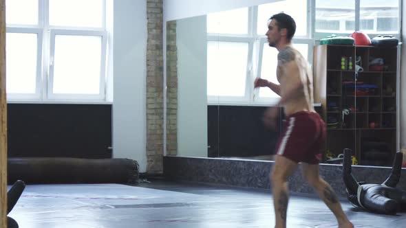 Professional Mma Fighter Training at the Gym Doing Spinning High Kicks