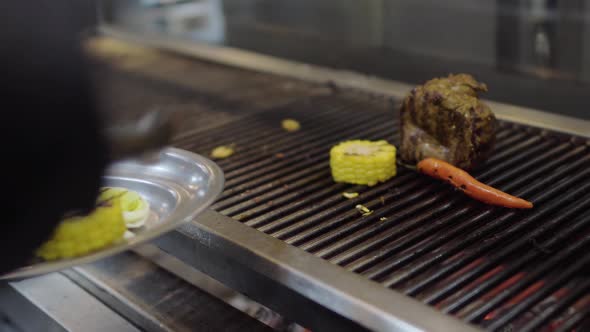 Professional Chef Cooking Vegetable on the Grill in the Restaurant Kitchen