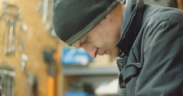 Man Working at Metal Industry - Cutting and Measuring Metal Parts at Workshop