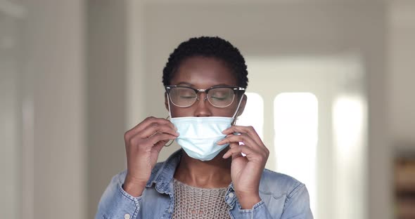 Pretty woman removing face mask, laughing happily