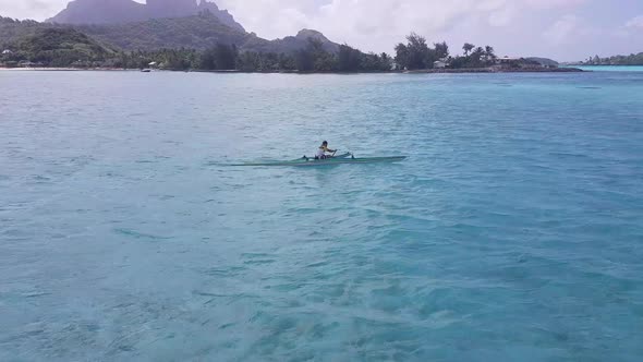 A Partner in Passenger or Sporting Kayak Events in the Middle of a Blue Singleseated Water Sitting