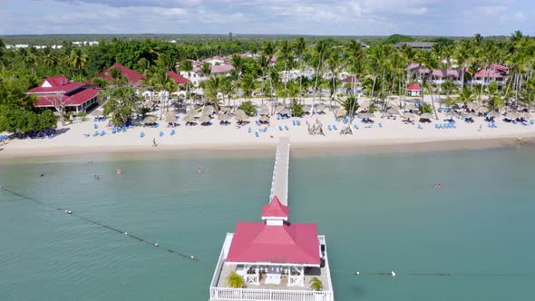 Drone pov flying over long pier and gazebo of Bahia Principe Hotel and Resort at La Romana, Dominica