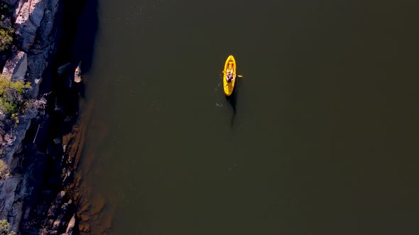 Aerial view woman on yellow kayak, Western Cape, South Africa.