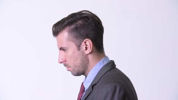 Profile View of Young Handsome Hispanic Businessman Looking Up