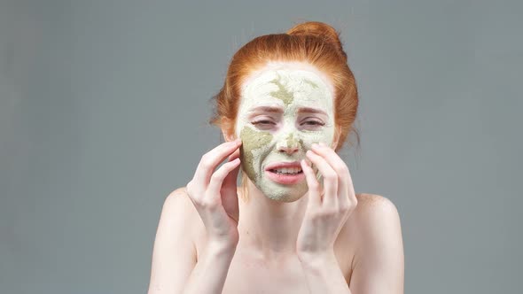 Beauty Portrait Face Mask. Anti-aging Facials. Young Woman Applies a Mask To the Face