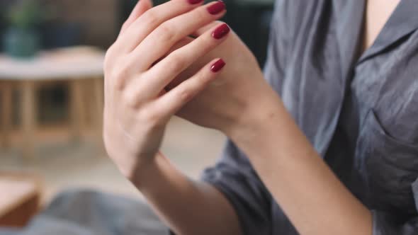 Woman Applying Cream On Hands