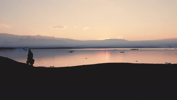 Silhouette Of Man Walking Through Icelandic Landscape