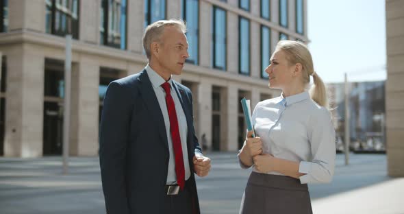 Business Colleagues Discussing New Project Outside Office in Urban Setting