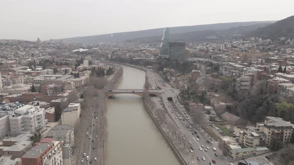 Aerial View of Galaktion Tabidze Bridge over Kura river in the centre of Tbilisi. Georgia 2021 April