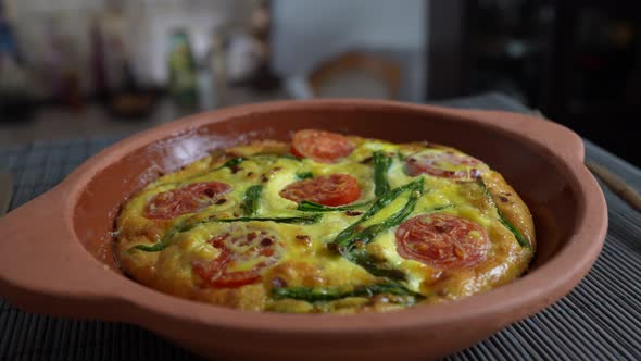 Vegetable frittata with egg, tomato, pepper, onion, cheese and green wild garlic