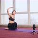 Slim Brunette Girl with Ponytail Sitting on Yoga Mat Raising Hands Bending on Yoga Mat - VideoHive Item for Sale