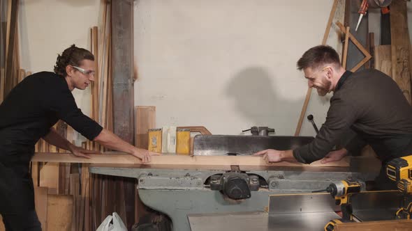Two Carpenters are Working in a Wood Factory