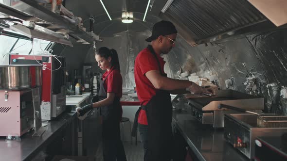 Man and Woman Working at Street Food Truck