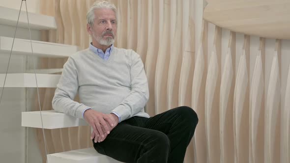 Relaxing Old Man Sitting on Staircase