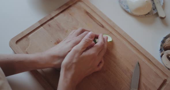 Close-up of female hands preparing ingredients for homemade pizza