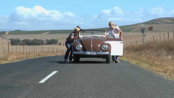 LS OF FRIENDS PUSHING A CAR