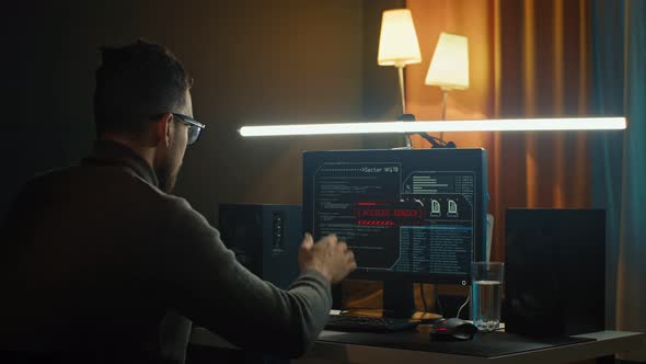 Digital Threat By Male Cyber Criminal Computer Hacker Typing Code While Trying to Break Into a