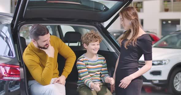 Portrait of Happy Caucasian Family in Car Dealership