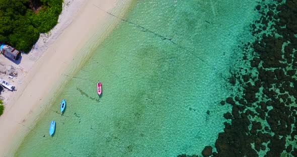 Daytime birds eye copy space shot of a paradise sunny white sand beach and aqua blue water backgroun