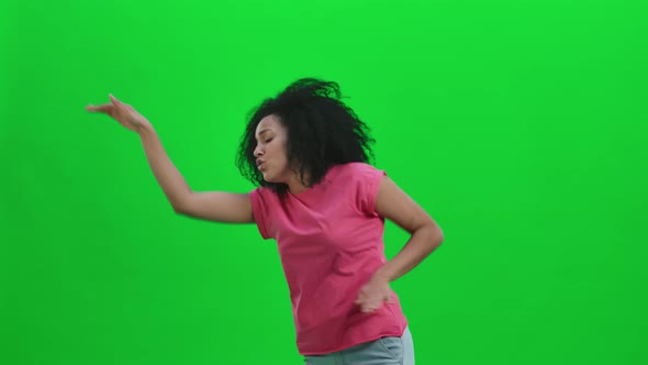 Portrait of Young Female African American Cheerfully Dancing the Dance of Victory Joy or Good Mood