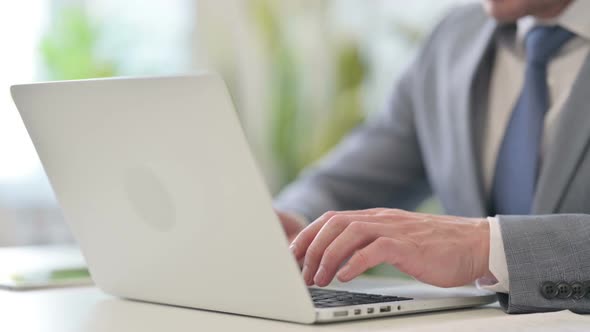 Close Up of Businessman Typing on Laptop