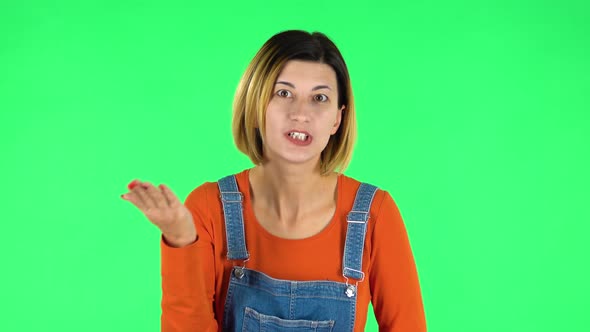 Girl Talks About Something Then Making a Hush Gesture, Secret. Green Screen