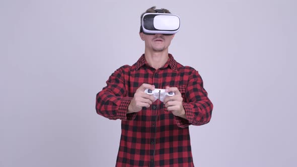 Hipster Man Playing Games with Virtual Reality Headset
