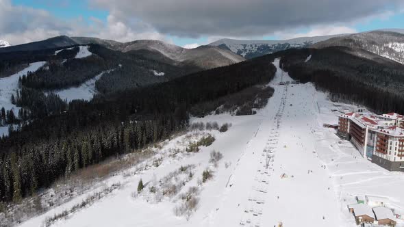 Aerial View on Lot of People Skiing on Ski Slopes Near Ski Lifts on Ski Resort