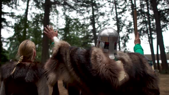 Viking Ceremony in which participants enthusiastically raise hands to the gods