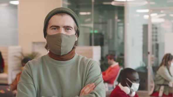 Portrait of Man in Face Mask Posing in Workplace