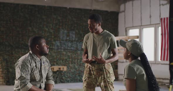 Black Soldiers Chatting in Gym