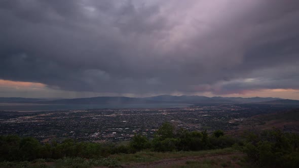 Time lapse at dawn from viewpoint over Utah Valley as the sun lights the clouds