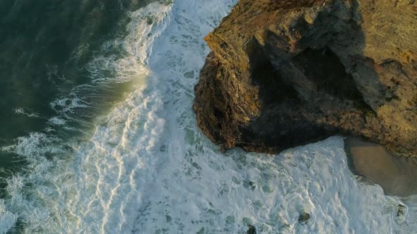 Slow motion coastal erosion of the cliffs along the coastline, drone aerial shot