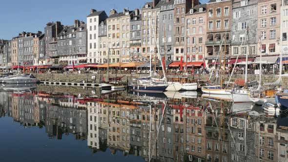 HONFLEUR, FRANCE - SEPTEMBER 2016 Natural light reflections of buildings and boats in Normandy famou