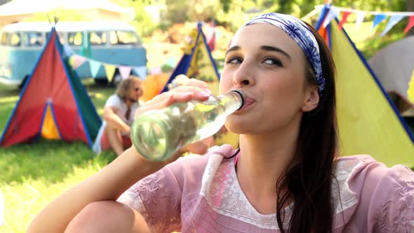 Hipster woman drinking water