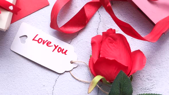 Close Up of Gift Box, Envelope and Rose Flower on White Background 