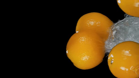 Group of Delicious Oranges are Bouncing Horizontally with Water Splashes