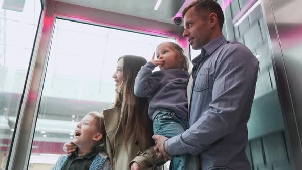 Family Rides the Elevator in the Mall