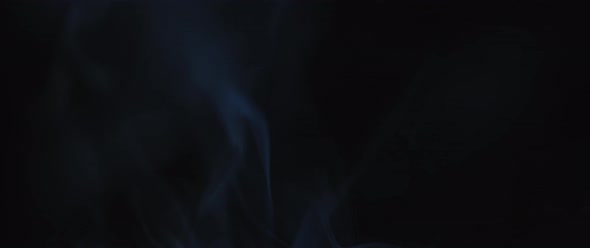 Blue incense smoke swirling in slow motion alt