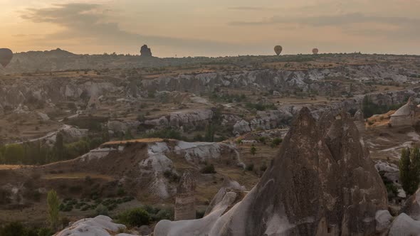 Colorful Hot Air Balloons Flying in Clear Morning Sky with Orange Clouds Aerial Timelapse in