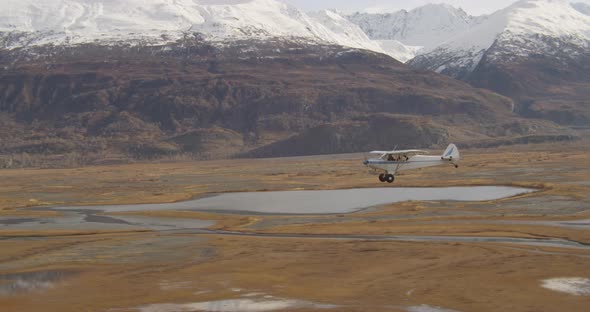 Helicopter aerial shot tracking over icy Alaskan ocean, drone