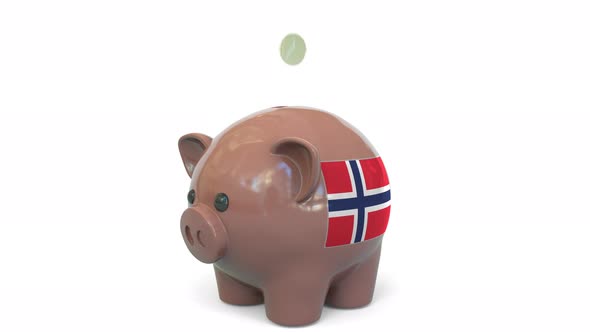 Putting Money Into Piggy Bank with Flag of Norway