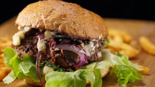 Close Up of a Grilled Hamburger with Onions and French Fries