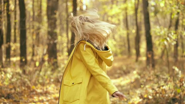 Woman having fun, running in the autumn forest