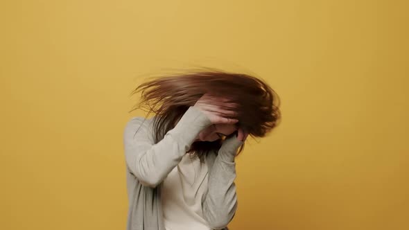 Woman Smiling Dancing to Music Rhythmically to Beat Moving on Yellow Background