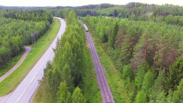 Railroad and highway side by side in the middle of the forest. Typical Finnish scenery. July 2018.