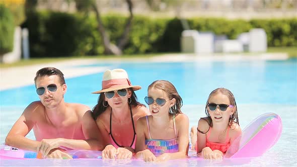 Happy family in swimming pool