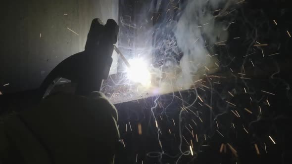 Close-up hand of Metal welder working with an arc welding machine.