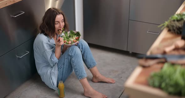 Woman with Healthy Green Food on the Kitchen